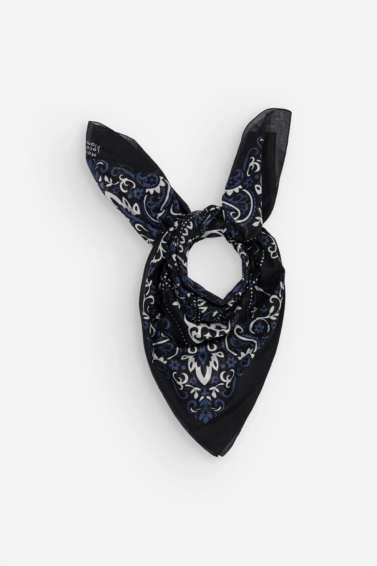 Introducing the MAISON LECOMTE - COSTA BRAVA BLACK SARONG by MAISON LECOMTE FLAMENT—a rectangular sarong adorned with intricate blue, white, and black symmetrical floral and paisley motifs, beautifully mirrored across a dark background.
