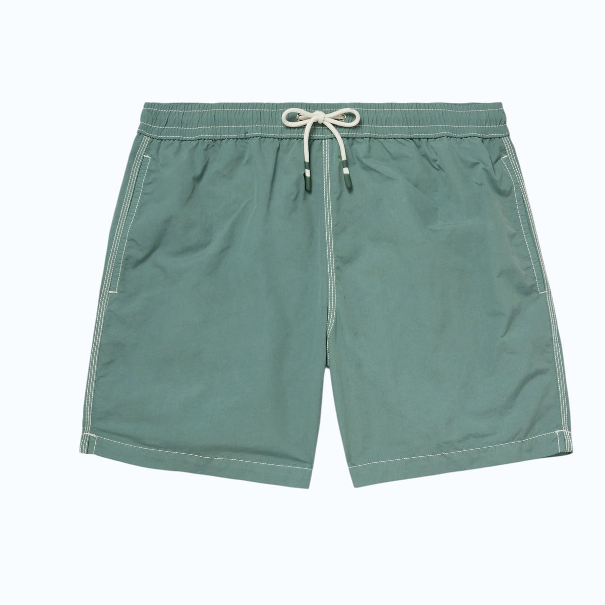 A pair of HARTFORD nylon swim trunks in Faded Kelly with white stitching and side pockets, shown flat on a light background. Includes travel pouch.