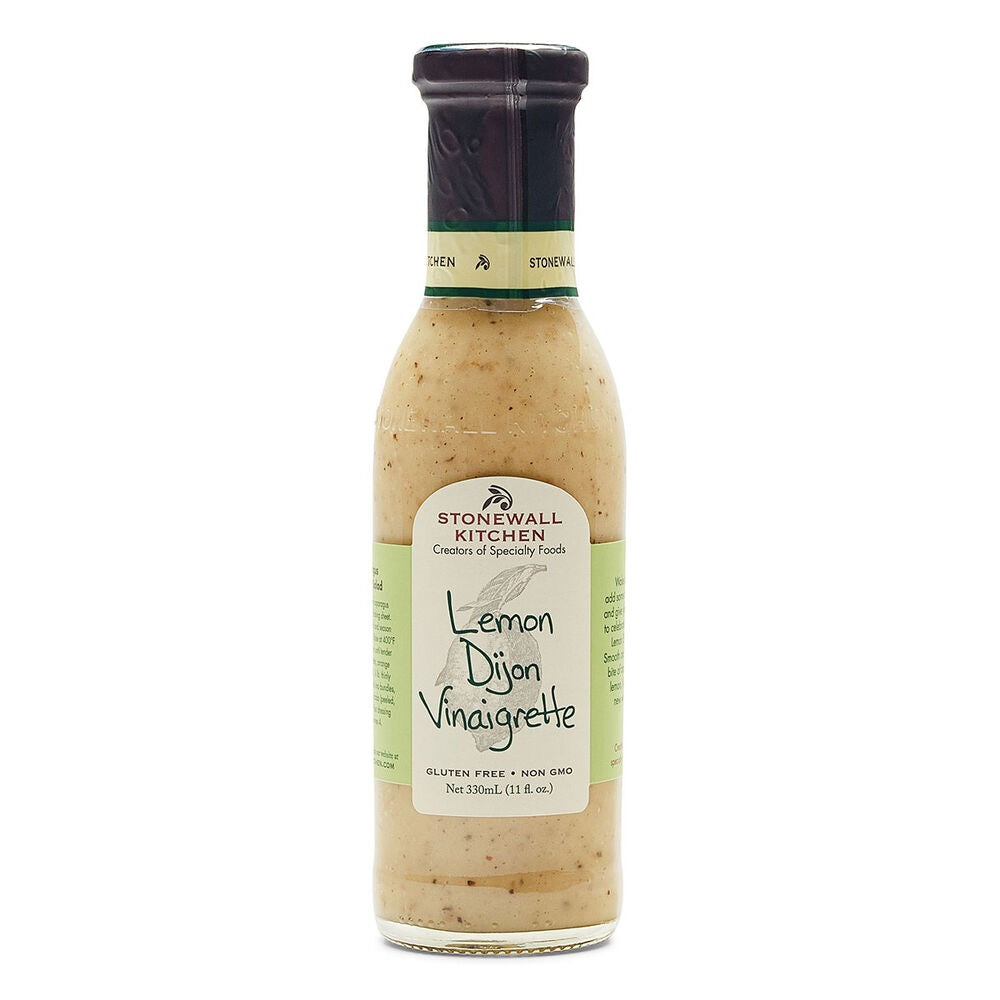 A bottle of STONEWALL KITCHEN - LEMON DIJON VINAIGRETTE by STONEWALL KITCHEN, featuring label details such as gluten free, non-GMO, and 330ml (11 fl oz). This tangy beige-colored vinaigrette salad dressing comes in a bottle with a black cap.