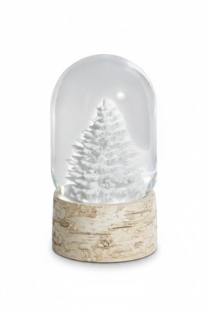 A Zodax SNOWGLOBE WITH TREE ON BIRCH BASE features a glass snow globe with a white pine tree set upon a decorative birch picture frame base.