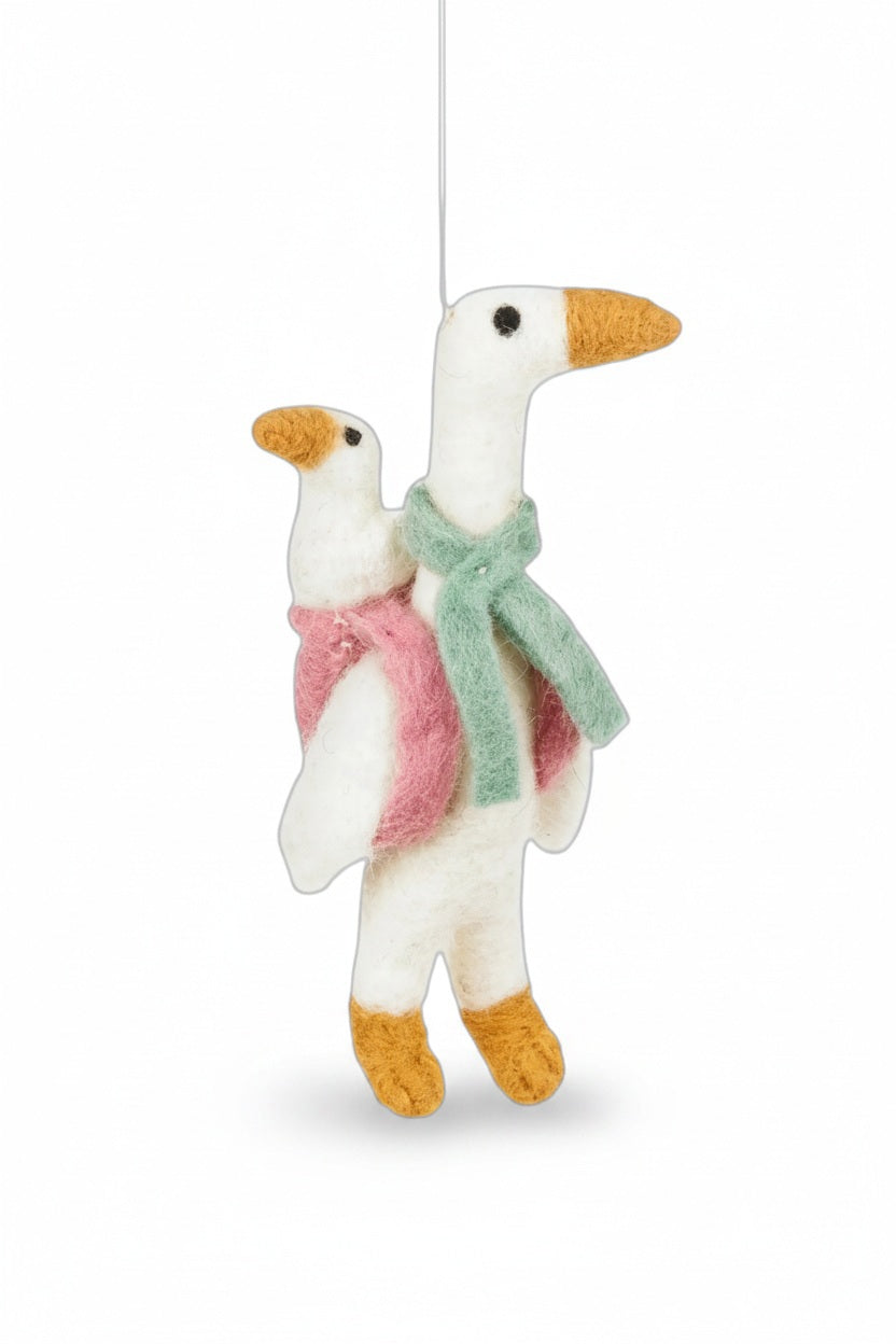 MOTHER GOOSE ORNAMENT by FELT SO GOOD, a handmade needle felted white bird wearing a green scarf and carrying a smaller goose on its back.
