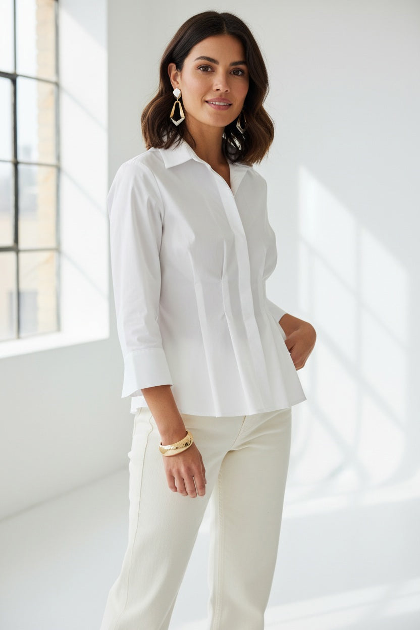 A woman with long red hair wears the HINSON WU - MARTINA 3/4 SLEEVE STRETCH POLISHED COTTON SHIRT IN WHITE, paired with matching white pants, standing against a plain light background.