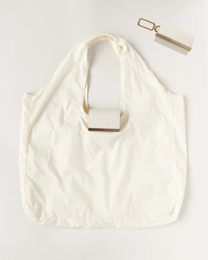 The KEOTE - KEYCHAIN TOTE IN CREAM by KEOTE is a stylish white reusable tote with a rectangular case attached to the handle and a matching cream keychain tote case with keyring, displayed on a white background.