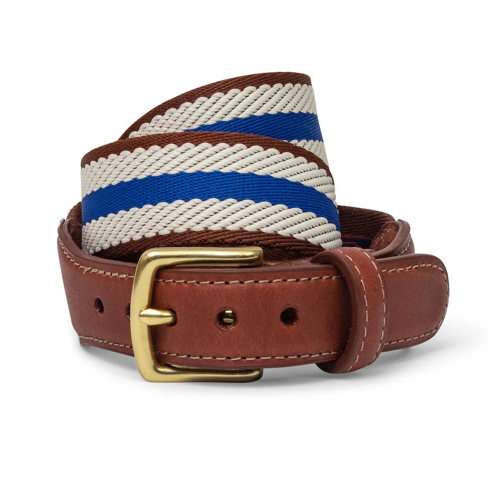 The BIRD DOG BAY COLLARED GREENS Dockside Belt in Navy/Ivory/Brown features a classic woven fabric with leather accents and a gold buckle, coiled neatly against a white background—ideal for fans of timeless style.