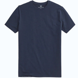 A man with short dark hair stands with his back to the camera, wearing the MACK WELDON Silver Crew Neck T-Shirt in True Navy and dark pants against a light gray background.