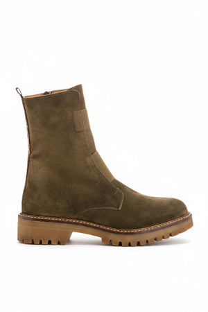 The REQINS Dusky Suede Ankle Boots in Khaki feature olive green suede leather, a chunky brown cleated heel, visible stitching, a pull tab at the back, and a rugged tread. A side zipper allows for easy wear.