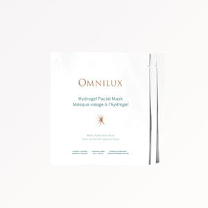 A woman removes an OMNILUX - HYDROGEL FACIAL MASK infused with Hyaluronic Acid from her face. Text above reads, “Includes 3 Hydrogel Facial Masks by OMNILUX.”.