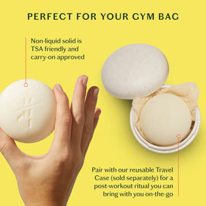 A person in a white robe rubs the KATE MCLEOD RECOVERY STONE | SOOTHING MUSCLE BALM on their thigh, with text highlighting its benefits: soothes sore muscles, reduces stress, is mess-free, and deeply nourishes dry skin.