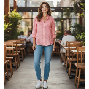 The FRANK & EILEEN - EILEEN Relaxed Button Up in Italian Linen Red and White Grid features a long-sleeve, collared design with slightly rolled sleeves and a relaxed fit. Expertly crafted from luxurious Italian linen, this shirt showcases bust-flattering button placement and a striking red and white grid pattern. The shirt is labeled “Frank & Eileen EST 1947.”.
