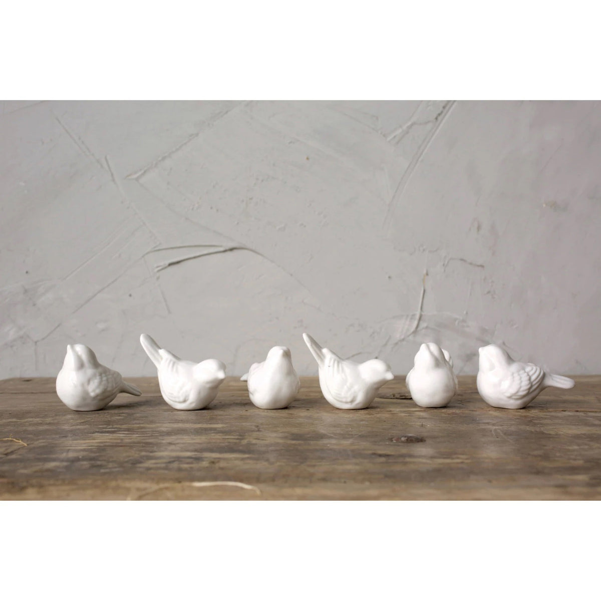 Six CREATIVE COOP 2.5&quot; CERAMIC BIRD figurines, smooth and white, sit with slightly raised heads in two rows of three against a plain background.
