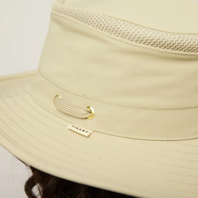 The TILLEY AIRFLO Broad Brim Hat LTM6 in Khaki Olive features mesh ventilation around the crown for outdoor use. Shown on a plain light background, this wide-brimmed sun protection hat is crafted by TILLEY.