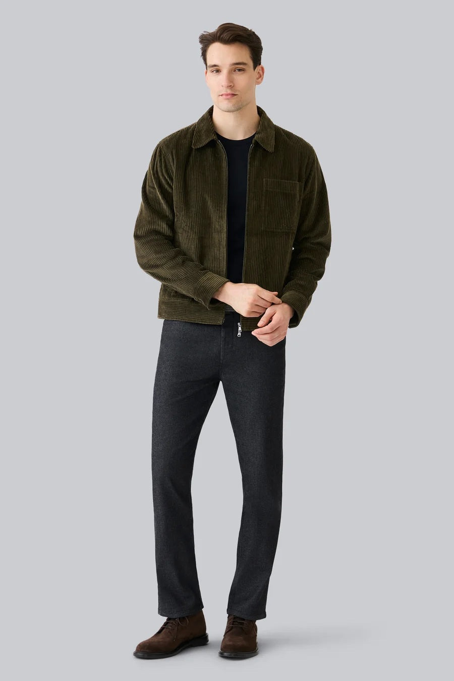 The MACK WELDON - CORDUROY ZIP JACKET is a modern-fit, dark blue corduroy jacket with a front zipper, long sleeves, collar, and chest pocket—shown against a white background.