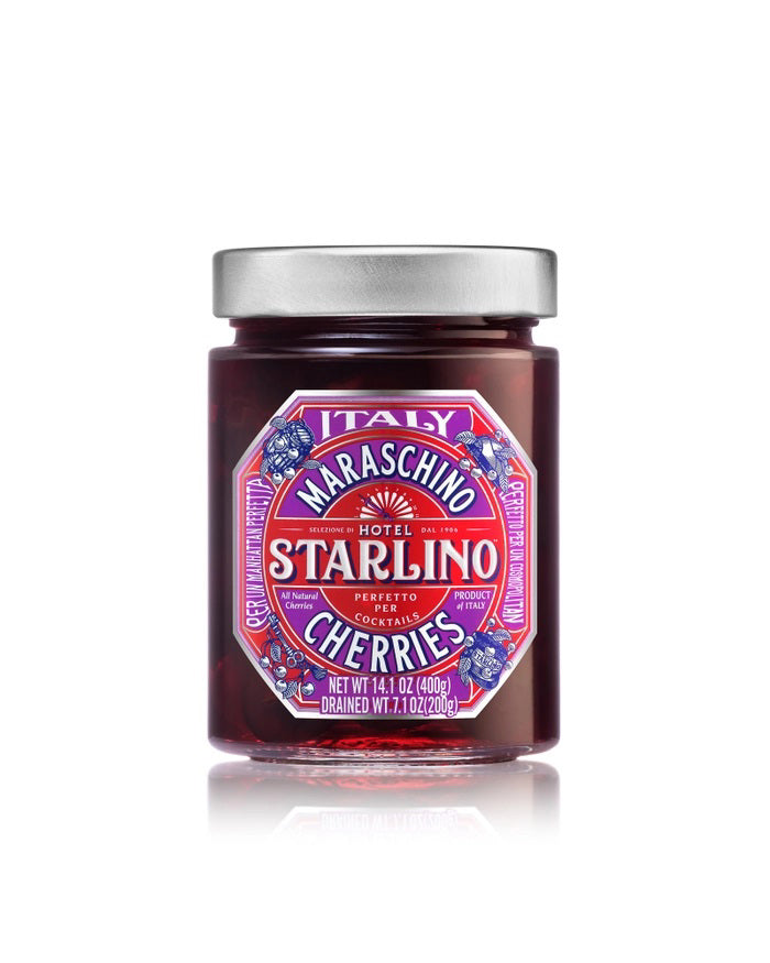 A jar of STARLINO ITALIAN MARASCHINO CHERRIES from the HOTEL STARLINO ITALIAN MARASCHINO brand features a vibrant red label adorned with intricate designs and proudly declares its Italian origin. Weighing 14.1 oz (400g), these luxury Maraschino cherries make an exquisite cocktail garnish.