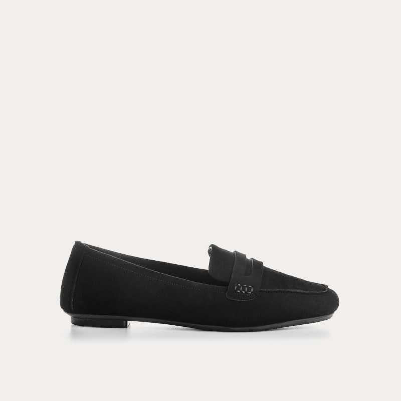 The REQINS HEMA Suede Loafer in Noir features a classic black silhouette, low heel, leather insole, and decorative front strap, shown against a plain light background.