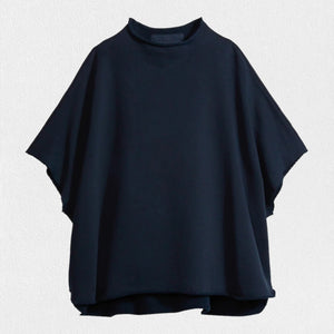 The FRANK & EILEEN Audrey Funnel Neck Capelet in British Royal Navy is a simple, loose-fitting dark navy blue t-shirt. Made from 100% cotton fleece, it features a high neckline and short sleeves with a boxy, relaxed silhouette against a white background.