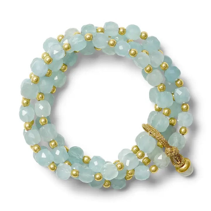 Introducing the CC & CO BY CATHERINE CANINO Sally Stack Bracelet in Aqua—a coiled bracelet adorned with faceted light blue aqua beads and petite gold accents, finished with a gold clasp and an elegant cluster set design.