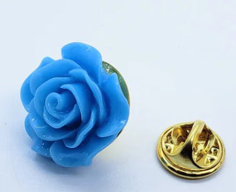 The CLIFTON WILSON - RESIN LAPEL FLOWER PIN is a detailed yellow rose accessory with smooth petals, evoking elegance and charm—a unique formalwear accent—presented against a plain white background.