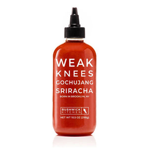A 10.5 oz (298g) bottle of BUSHWICK KITCHEN - 'WEAK KNEES' GOCHUJANG SRIRACHA hot sauce features a striking red design with a black cap and white text, proudly made in Brooklyn, NY, USA. This unique blend includes fermented chile paste for an exceptional kick.