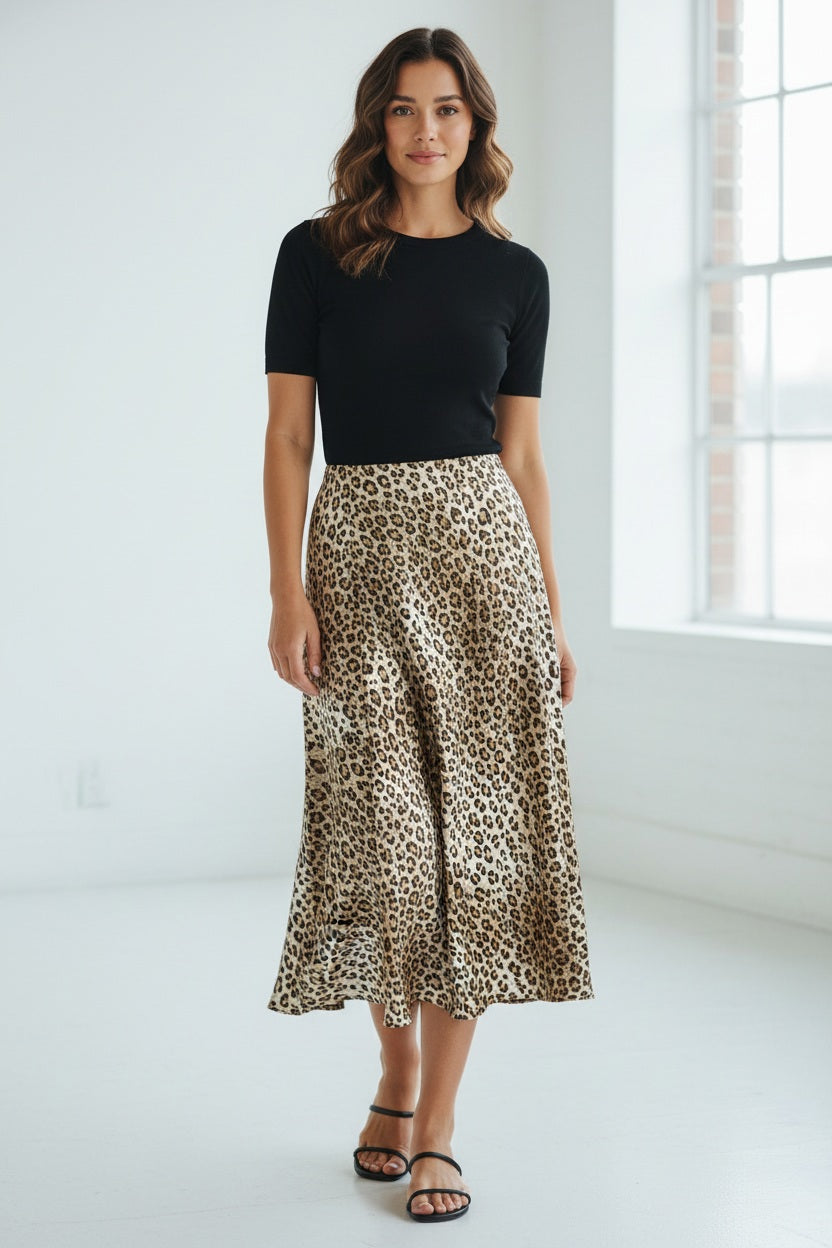The SEVENTY VENEZIA - LEOPARD PRINT SKIRT by SEVENTY is a knee-length, A-line skirt with brown and black leopard spots on a light base, made in Italy and shown against a light beige background.