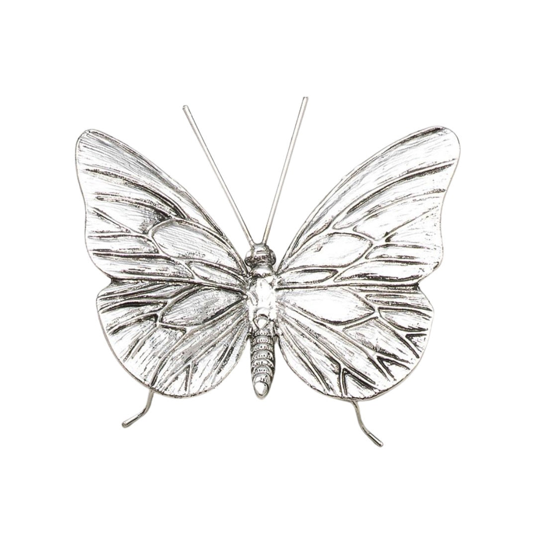 The ZODAX PEWTER BUTTERFLY is a silver metallic sculpture with textured wings, slender antennae, and thin legs. Measuring 4.25 x 3.25 x 1.75 inches, it’s perfect for display in a small box or on a shelf against any backdrop.