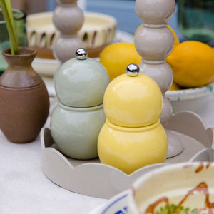 The ADDISON ROSS LONDON Chubbie Salt or Pepper Mill 12cm is a light gray, glossy, double-gourd-shaped lacquered grinder with a ceramic mechanism and silver knob, shown on a plain white background.