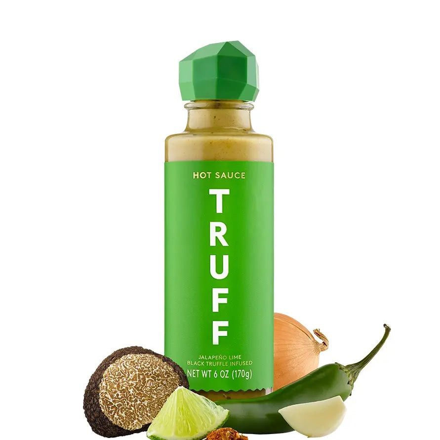 A bottle of TRUFF HOT SAUCE’s JALAPENO LIME HOT SAUCE, featuring a green label and cap marked “Jalapeño Lime,” stands upright on a white background, delivering a fresh twist on the classic TRUFF flavor.
