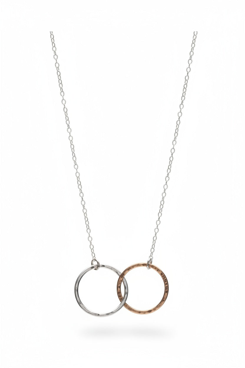 A close-up of KENDA KIST - THE BFF NECKLACE by KENDA KIST, a stunning two-tone interlocking circle necklace, perfect for celebrating friendship.