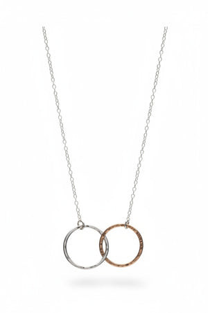 A close-up of KENDA KIST - THE BFF NECKLACE by KENDA KIST, a stunning two-tone interlocking circle necklace, perfect for celebrating friendship.