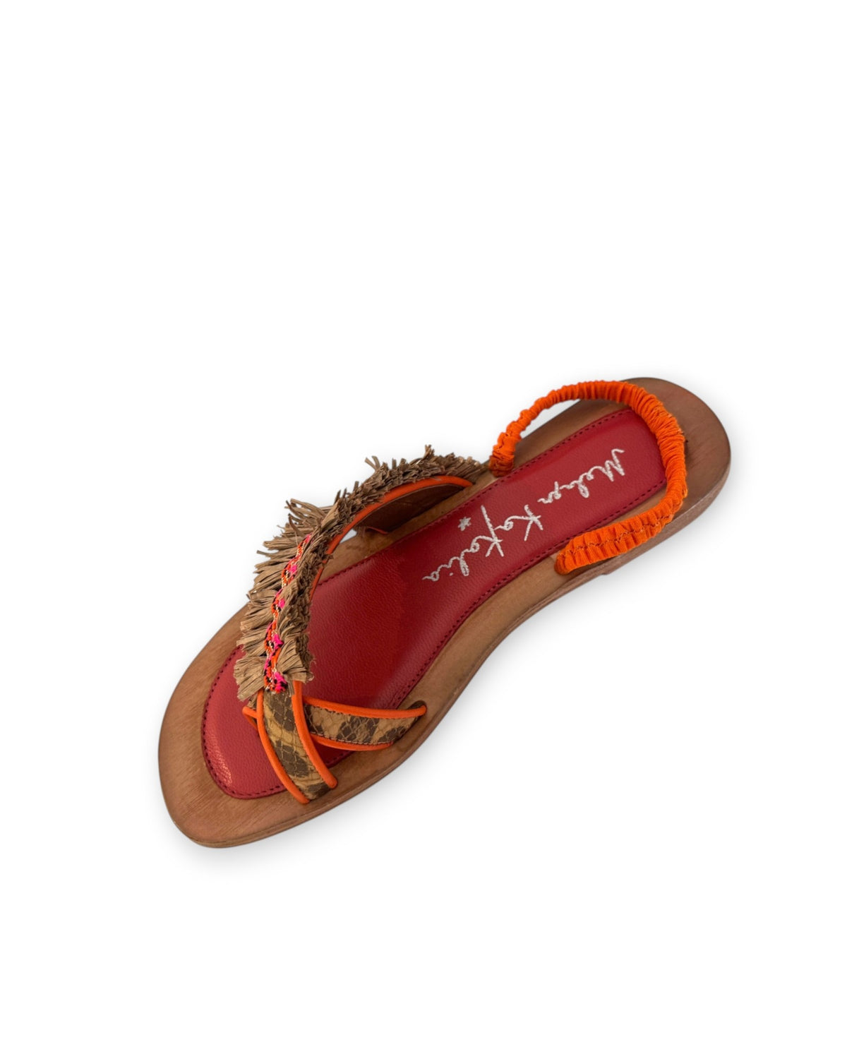 The MEHER KAKALIA - HAMAM SLIDE IN LEOPARD KHAKI sandal by MEHER KAKALIA features a flat toe-ring design with a wooden sole, vibrant red insole, orange heel strap, and brown textured raffia upper straps adorned with decorative accents.