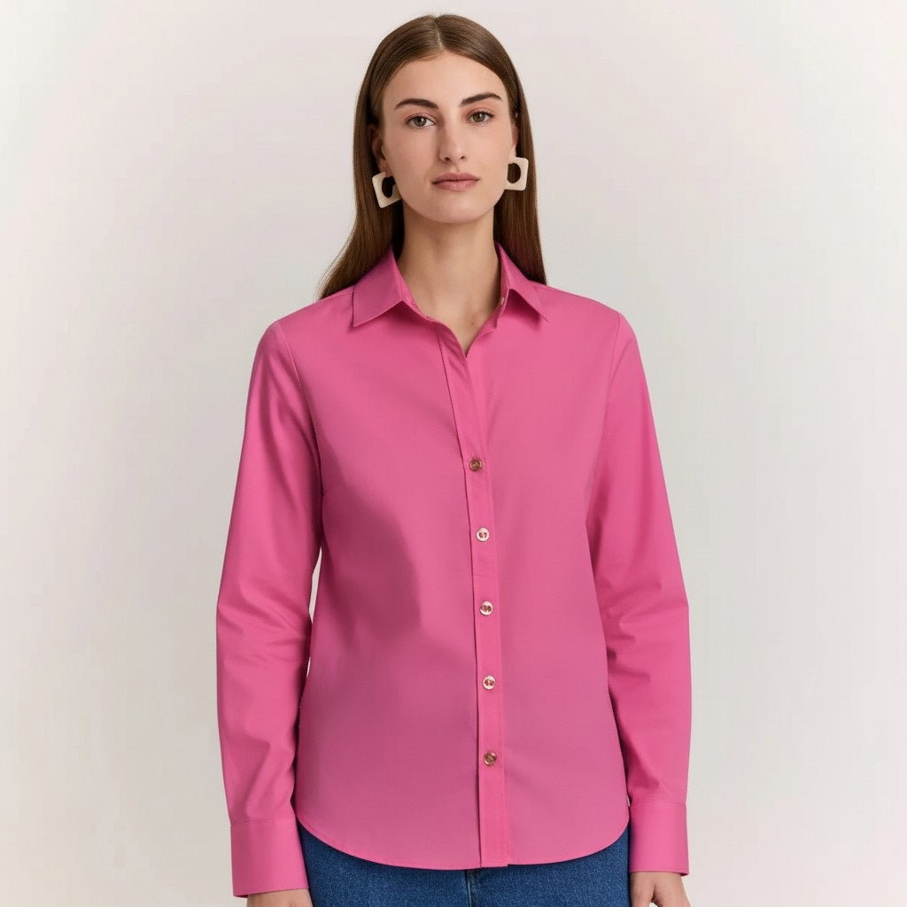 A woman with straight brown hair wears the HINSON WU Clarice Long Sleeve Shirt in Guava and blue jeans, standing against a plain light background and looking directly at the camera with a neutral expression.