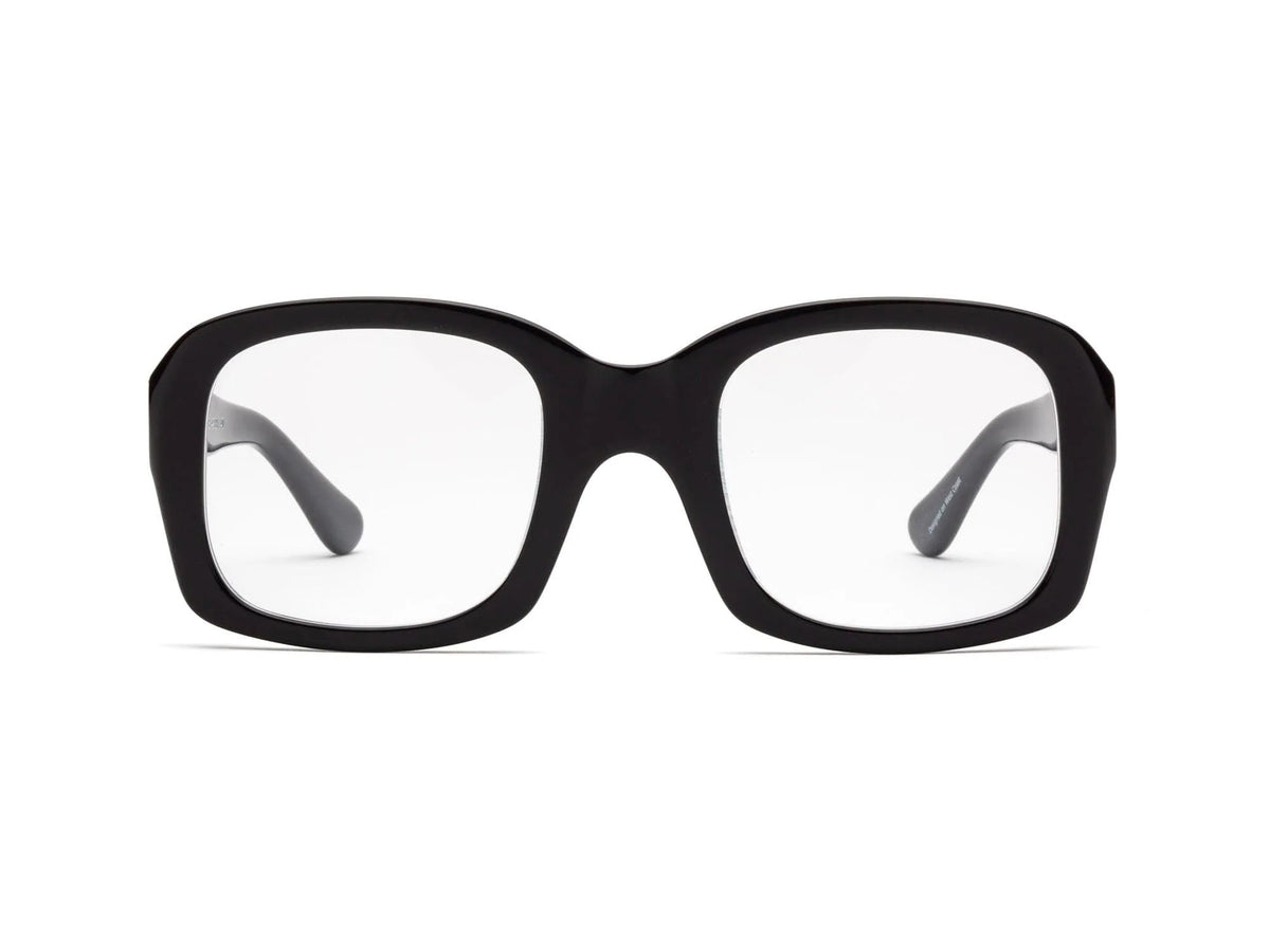 CADDIS - SHELBY PROGRESSIVE READERS by CADDIS are black, square, thick-rimmed eyeglasses with oversized frames and clear, scratch-resistant lenses. Shown front-facing on white; "Shelby" printed in white inside the left arm.