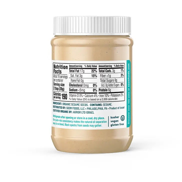 A jar of SOOM - ORGANIC TAHINI from SOOM FOODS, crafted entirely from silky-smooth, roasted and ground Ethiopian sesame seeds. The label proudly displays the USDA Organic certification and indicates a net weight of 16 ounces (453 grams). Additionally, it features an illustration of a spoon alongside ingredients such as carrots and cucumbers.