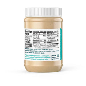 A jar of SOOM - ORGANIC TAHINI from SOOM FOODS, crafted entirely from silky-smooth, roasted and ground Ethiopian sesame seeds. The label proudly displays the USDA Organic certification and indicates a net weight of 16 ounces (453 grams). Additionally, it features an illustration of a spoon alongside ingredients such as carrots and cucumbers.