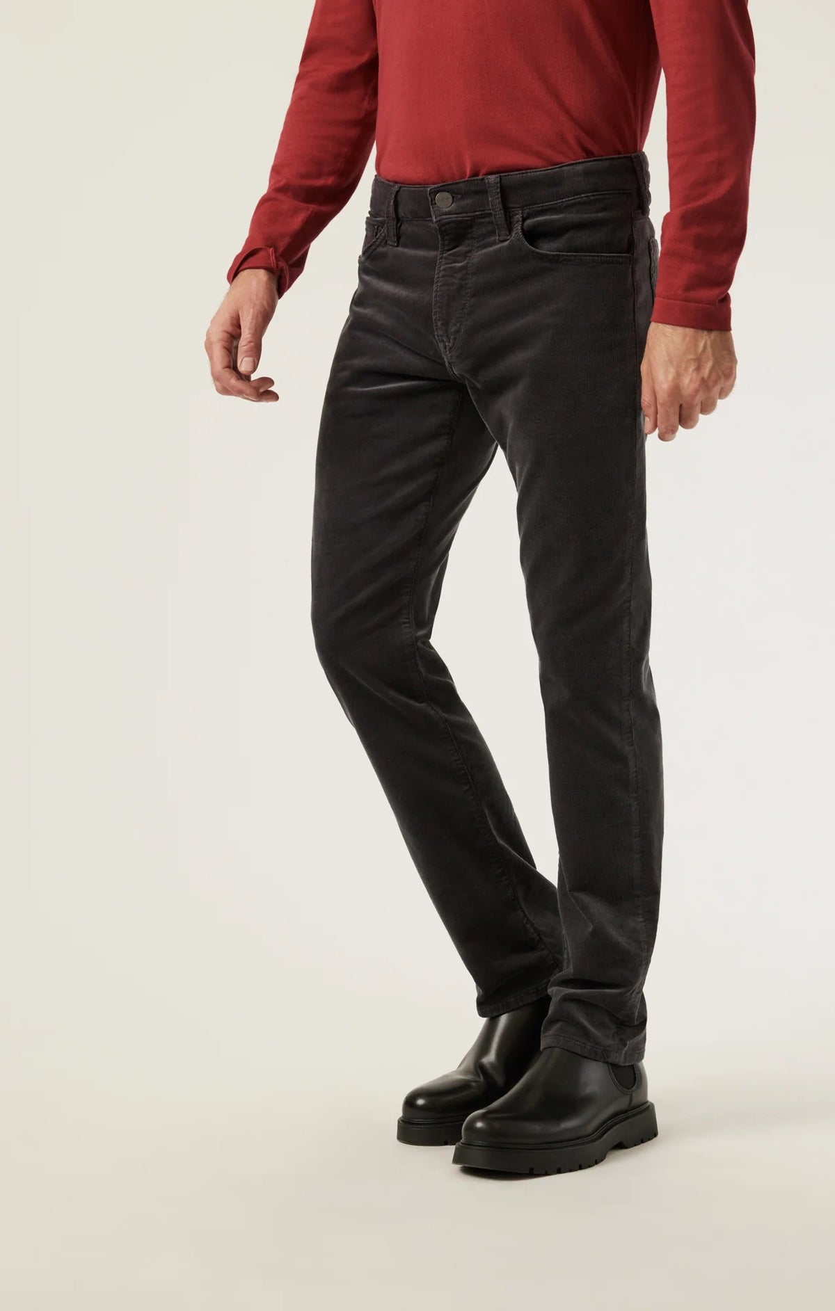 34 HERITAGE - CHARISMA RELAXED STRAIGHT LEG CORDUROY PANTS IN CHARCOAL worn with a red long-sleeve shirt and black leather boots.