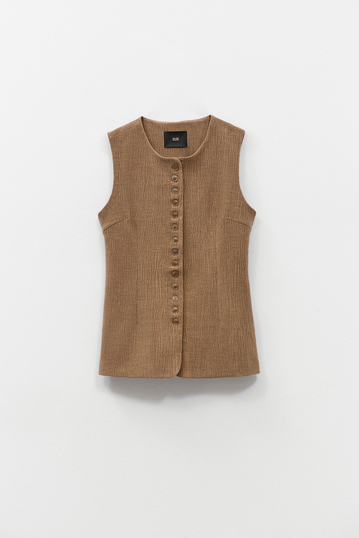 ELEH - THE ATLIER VEST by ELEH: A sleeveless, textured brown crinkle fabric vest with a round neckline and small front buttons, shown against a white background.