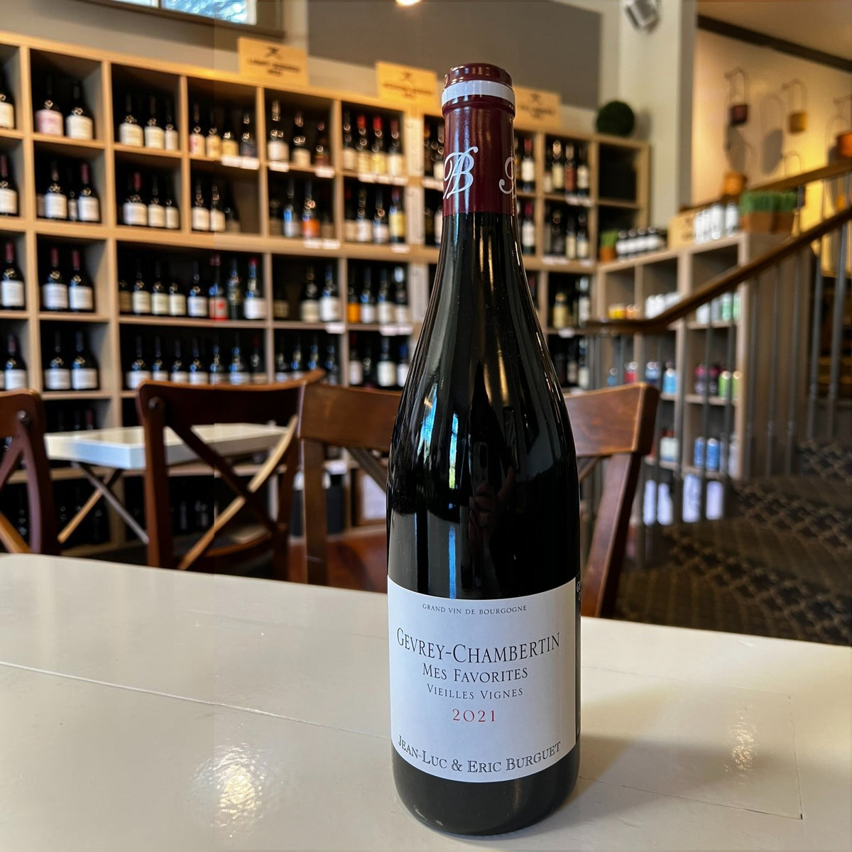 A bottle of ALAIN BURGUET ‘MES FAVORITES’ GEVREY CHAMBERTIN 2021 red wine with a white label featuring the text “Mes Favorites,” “Vieilles Vignes,” “2021,” and the names “Jean-Luc & Eric Burguet.”