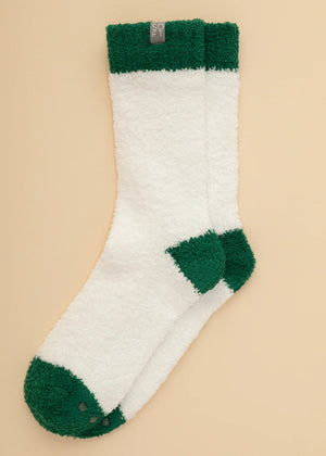 A pair of SOFTIES - MARSHMALLOW CREW SOCKS IN WHITE WITH GREEN HEEL worn on legs, featuring a white marshmallow design with green heels, toes, and cuffs.
