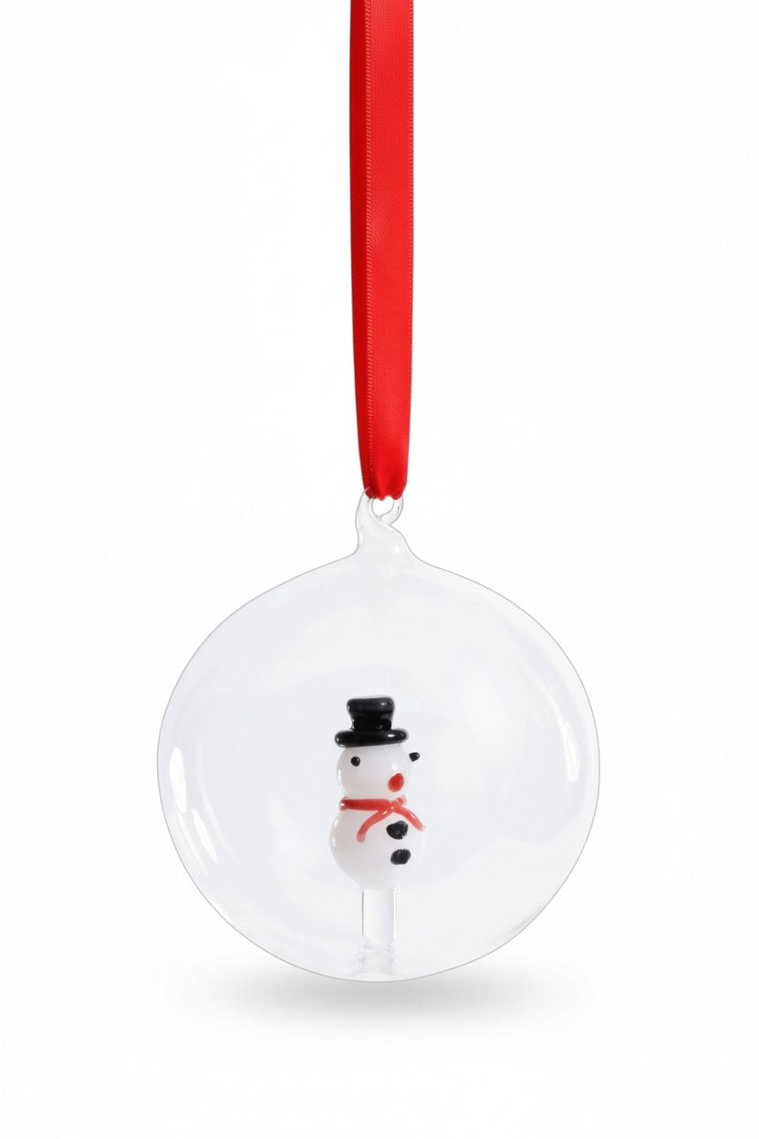 ZODAX SNOWMAN GLASS ORNAMENT: a clear 4-inch glass ball containing a small snowman figure, hung from a red ribbon.