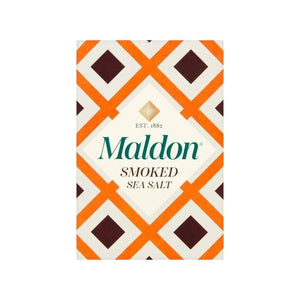 A box of MALDON - SMOKED SEA SALT from GOURMET FOOD SOLUTIONS is shown against a pink background. The box features a geometric design with orange, brown, and white patterns that illustrate the artisanal quality of English sea salt, with the text "MALDON - SMOKED SEA SALT" prominently displayed on the front.