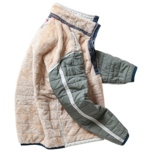 The RELWEN Quilted Superfleece Popover in Chalk is a beige fleece jacket with quilted green sleeves and white stripes, shown laid flat on a white background. This semi-water resistant fall-winter coat features a high collar and stylish navy blue trim along the zipper and collar for added protection and flair.