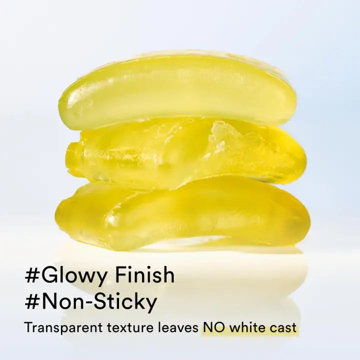 Two black ASIAN BEAUTY WHOLESALE QUICK SUNSTICK PROTECTION BAR 22G are shown: one open, revealing the pale yellow stick, the other closed. A swatch of the portable sunscreen is smeared above them on a white background.