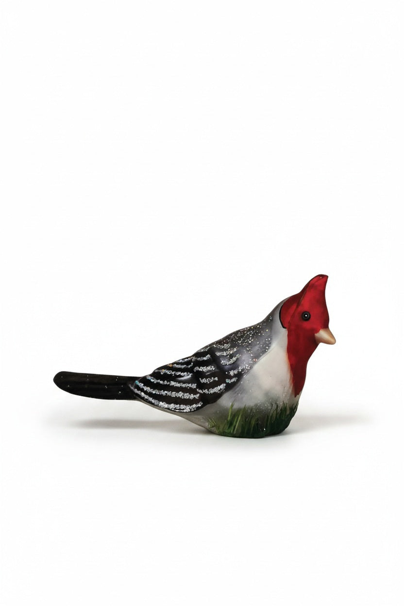 RED CRESTED CARDINAL CLIP ORNAMENT by Old World Christmas, featuring a glass bird with a bright red head and crest, black-and-white feathered wings, and a clip base, perched on a pine branch.