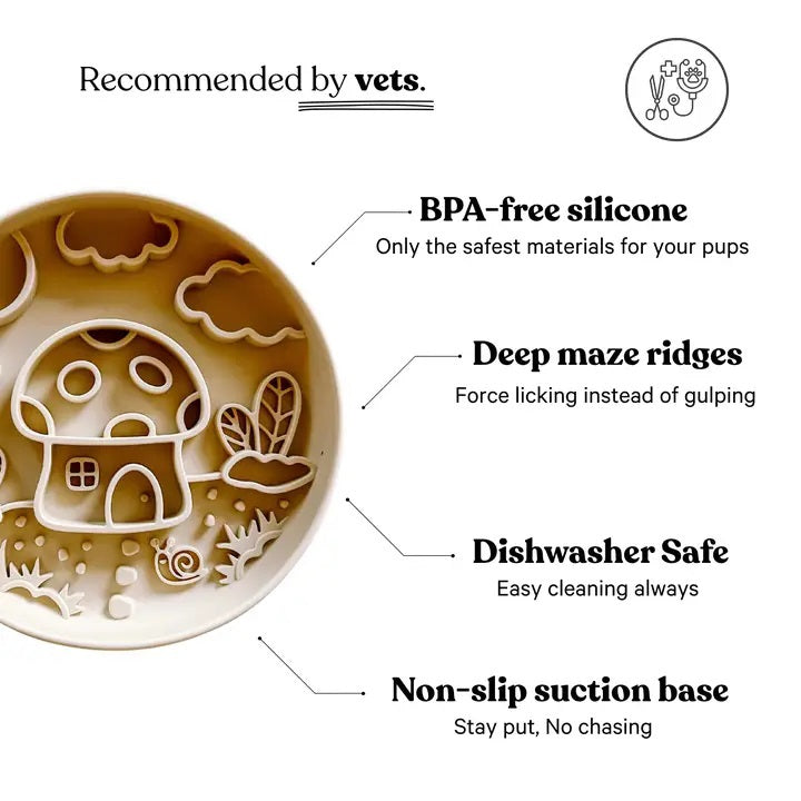Introducing the MUSHROOM SLOW FEEDER by BARKS & BROWNIES—a round beige plate featuring raised sections that create a delightful scene of a mushroom house, clouds, moon, plants, grass, and a small snail in the foreground. Thoughtfully outlined to keep food separated, this charming design encourages slower eating for your pup while making mealtime more enjoyable.