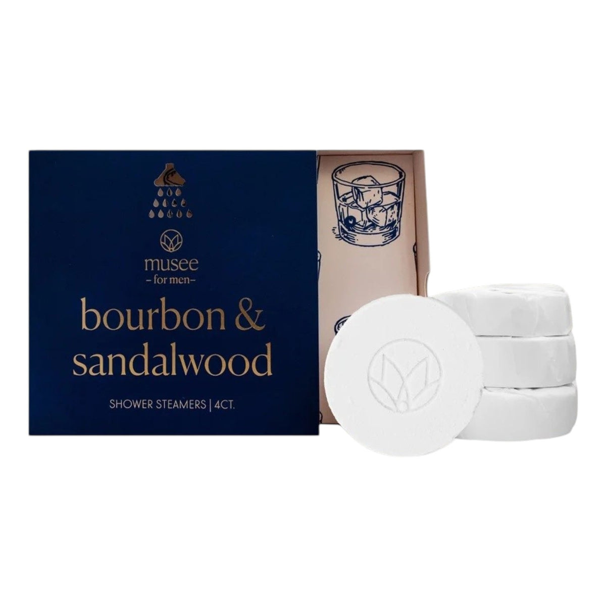 A blue box labeled “MUSEE - BOURBON &amp; SANDALWOOD SHOWER STEAMERS” by MUSEE sits beside four white round steamers and an open lid adorned with a drawing of a whiskey glass, offering an indulgent aromatherapy shower experience enhanced with sandalwood essential oil.