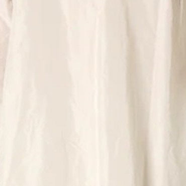 A close-up of a black fabric, likely part of KATHARINA HOVMAN&#39;s Cropped Pant in Taffeta. The smooth texture with subtle wrinkles suggests lightweight material, perfect for casual 3/4-length pants featuring an elastic waistband.