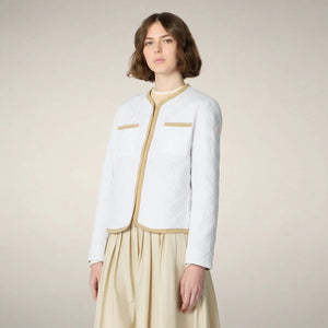 The SAVE THE DUCK JALINA PUFFER JACKET features diamond quilting, long sleeves, two chest pockets, and tan trim on the collar, zipper, cuffs, and hem. Displayed on a plain light background.