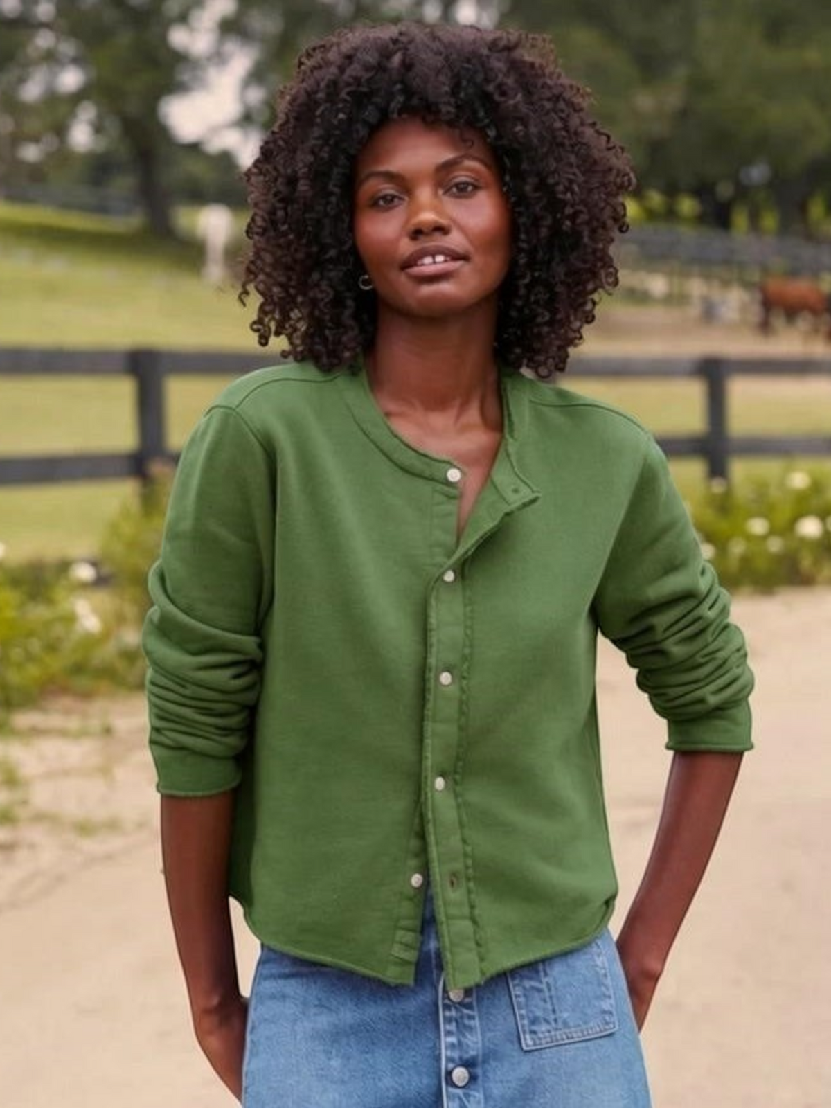 Fearrington Village model wearing a green Frank and Eileen Jackie sweatshirt cardigan with raw edges and buttons.