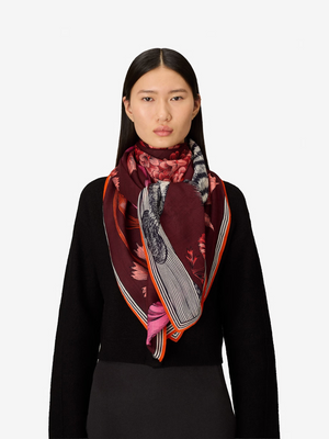 Fearrington Village Inoui Editions Gustav wool scarf in burgundy with floral print worn by a model