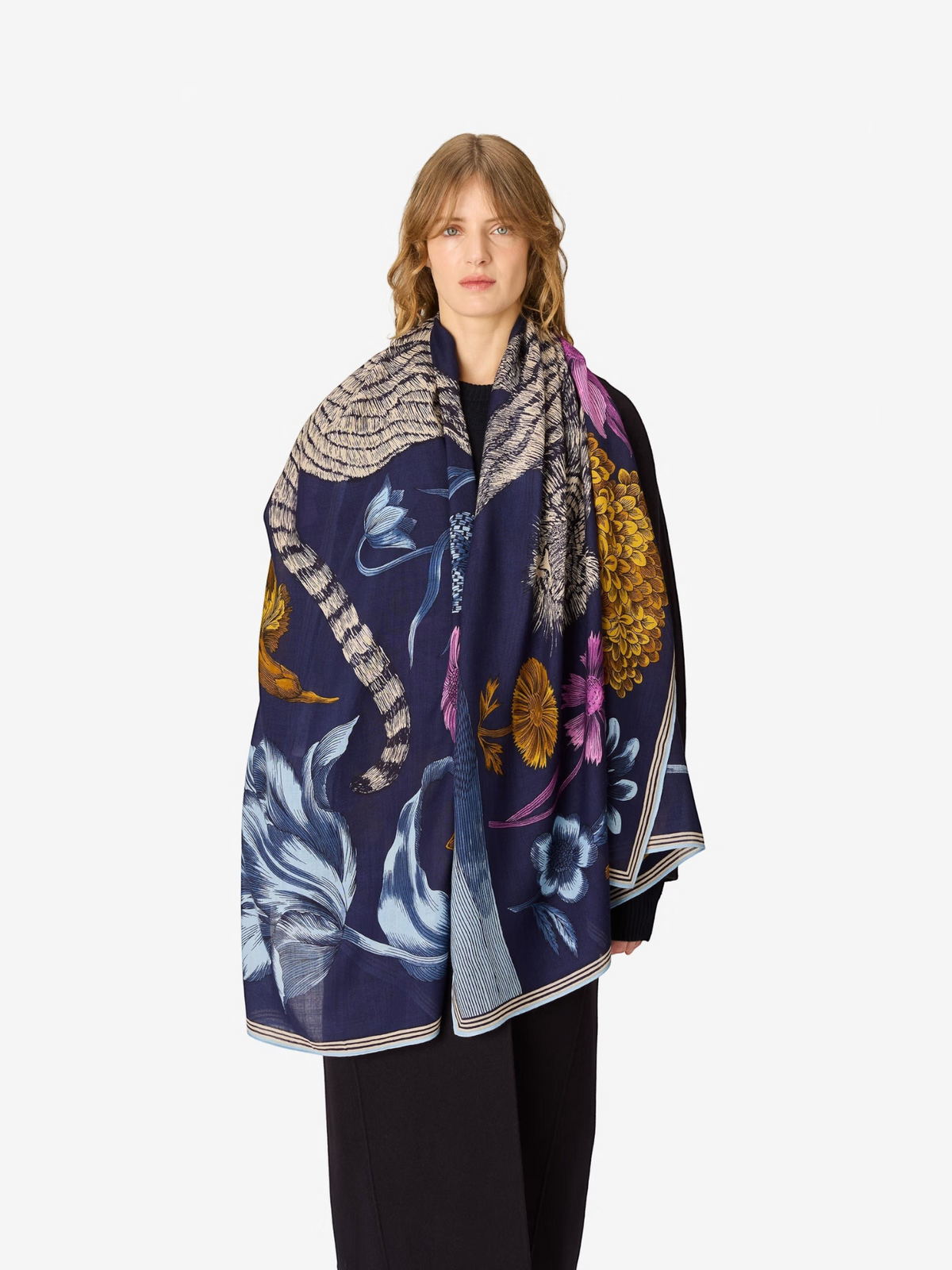 Fearrington Village Inoui Editions Gustav navy wool scarf with intricate floral and animal print draped on a model