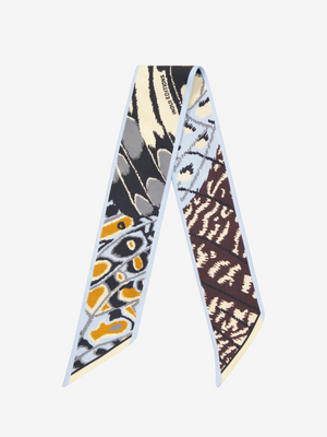Fearrington Village INOUI EDITIONS silk ribbon featuring a colourful butterfly wing pattern in brown, grey, and yellow.